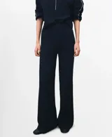 Pantalón de punto azul marino de corte recto y tiro alto, con ribete blanco en los laterales.