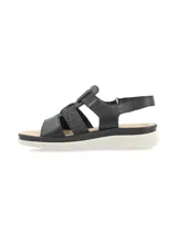 Sandalia de cuero negro estilo cangrejera, con tiras elásticas con glitter, suela anatómica liviana de color blanco y tira trasera ajustable con velcro.