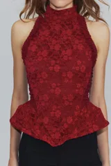 Corset bordó de cuello halter con hombros descubiertos, confeccionado con combinación de tejidos con patrón floral, detalles de volados en las sisas y bajo en peplum. Cuenta con cierre en la espalda con cremallera.