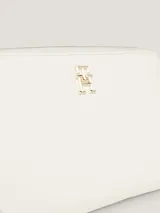 Billetera Tommy Hilfiger Iconic de poliuretano color blanco, con cierre de cremallera, insignia metálica del monograma TH y múltiples ranuras interiores para tarjetas, monedas y billetes.