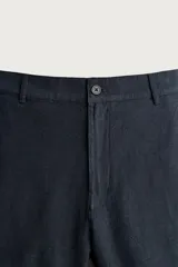 Bermuda de corte regular fit confeccionada en tejido mezcla de algodón y lino. Presenta cierre frontal con cremallera y botón, bolsillos laterales y bolsillos traseros de vivo.