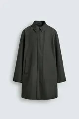 Gabardina impermeable de corte regular fit en color verde militar, con cuello solapa, manga larga con puño ajustable con botones a presión y bolsillos de vivo en la cadera. Cierre frontal con cremallera oculta por solapa con botones a presión.