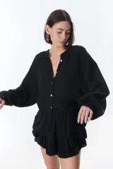 Camisa marrón de lino con cuello mao, mangas largas y corte holgado.