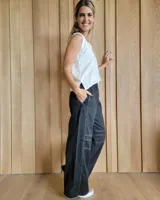 Pantalón de algodón color arena, de corte recto y holgado, con cintura elástica y detalle de costuras horizontales decorativas en la parte inferior de las piernas.