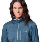 Buzo polar Columbia de mujer con cierre frontal parcial, cuello alto y bolsillo con cierre en el pecho. Presenta un diseño técnico con tecnología Omni-Wick para absorción de humedad y ribetes en contraste en cuello y puños.