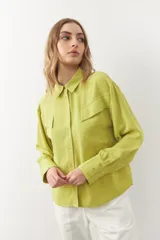 Camisa blanca de manga larga con dos bolsillos grandes con solapa en el pecho.