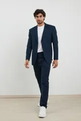 Saco azul oscuro con solapa de muesca, cierre de dos botones, dos bolsillos delanteros con solapa y un bolsillo en el pecho. Corte clásico.