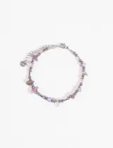 Pulsera de acero quirúrgico con diseño de cuentas facetadas oscuras, pequeñas barras metálicas y piedras naturales en tonos violeta y lila. Incluye cadena de alargue y dije circular con la inscripción S.steel.