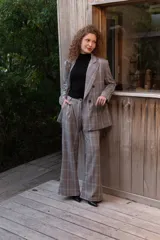 Pantalón sastrero de tiro alto con estampa a cuadros en tonos grises, rojos y blancos, de corte recto y holgado.