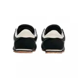 Championes Vans modelo Super Lowpro, de diseño urbano y perfil bajo. Presentan una combinación de gamuza negra en puntera y talón con paneles laterales de lona, destacando la icónica banda lateral Sidestripe en color blanco. Incluyen cordones blancos, suela de goma color caramelo y detalles de costuras visibles.