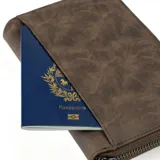 Billetera marrón de cuero con cierre de cremallera y logo Baleine grabado en la esquina inferior derecha.