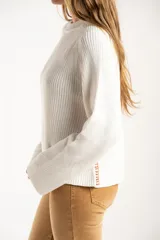 Sweater de punto de algodón con diseño oversize, cuello redondo y mangas largas. Presenta un detalle de costura lateral en color contrastante.