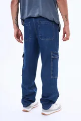 Pantalón cargo de denim negro con corte holgado, bolsillos laterales con solapa y cierre frontal con botón.