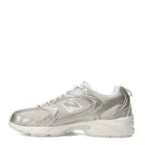 Championes urbanos New Balance modelo 530, con diseño retro inspirado en el running. Presentan una combinación de malla transpirable y revestimientos sintéticos en tonos beige y dorado metalizado, con la icónica letra N en los laterales y entresuela con tecnología ABZORB para mayor amortiguación.