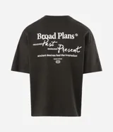 Remera de corte oversized color verde oscuro, con cuello redondo y mangas cortas. Presenta un diseño estampado en la espalda con tipografía en blanco y un pequeño logo gráfico en la parte inferior.
