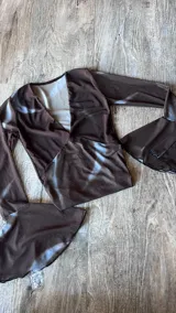 Remera marrón con estampado abstracto, mangas acampanadas y escote en V.