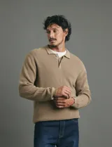 Remera de punto tipo polo con textura waffle, color verde petróleo, de manga larga y cuello con cierre de botones.