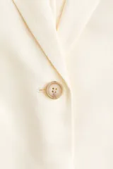 Blazer de botonadura sencilla en mezcla de lino y viscosa con solapas de muesca y cierre de un botón. Modelo con hombreras, pinzas moldeadoras adelante, abertura en los puños y bolsillos ribeteados con solapa, con abertura atrás y forrado.