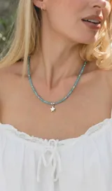 Collar de cristalitos facetados en tonos celestes con dije de estrella y cierre de acero.