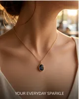 Collar de bronce con cadena fina dorada y dije colgante ovalado con piedra azul oscura.