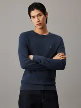 Sweater de cuello redondo Calvin Klein confeccionado en algodón orgánico con textura de micro piqué. Presenta puños y dobladillo en punto canalé y el logo de la marca bordado en el pecho.