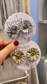 Par de aros con forma de flor, hechos artesanalmente en alpaca o bronce, con perno en Plata 925 y circonias.