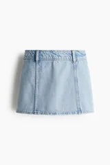 Pollera mini de corte evasé confeccionada en denim de lavado claro. Presenta costuras verticales decorativas y cintura con trabillas.