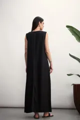 Vestido largo sin mangas, color verde militar, con cuello redondo y costura central vertical en contraste.