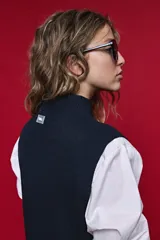 Chaleco de punto liviano color azul marino, con cuello alto y diseño sin mangas de silueta relajada.