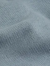 Sweater celeste de punto con cuello perkins, corte holgado y logo CK bordado en el pecho.