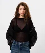 Blusa de manga larga con transparencia, confeccionada en viscosa y elastano. Presenta un diseño ajustado al cuerpo, cuello redondo y textura sutil, ideal para usar en capas.