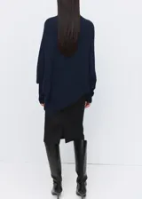 Jersey de punto azul marino, con cuello alto vuelto, de manga larga y diseño holgado.