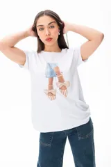 Remera blanca con estampado de zapatos con moños y vestido celeste.