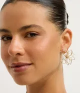 Aros medianos de metal dorado con diseño de flor irregular y hueca.