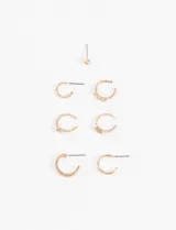 Set de aros dorados con strass, incluye un aro tipo botón y varios aros tipo earcuff de diferentes tamaños.