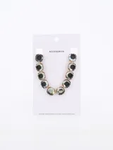 Gargantilla dorada con eslabones y gemas facetadas grises engarzadas.