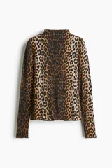 Top de punto con cuello alto y manga larga, con diseño de estampado de leopardo y terminaciones con remate sobrehilado en puños y bajo.