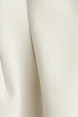 Top manga larga beige de interlock pesado con hombros caídos, escote redondo, pinzas moldeadoras en la cintura y bajo acampanado.