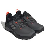Championes de senderismo Adidas Terrex AX4 GORE-TEX, color gris con detalles en negro y naranja. Cuentan con membrana impermeable GORE-TEX y suela de caucho Continental.