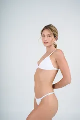 Conjunto de bikini blanco con corpiño triangular fijo y bombacha colaless regulable.