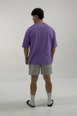 Remera negra de algodón, corte oversize, con inscripción 'GAINS.' en el frente.