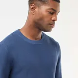 Sweater de punto fino con cuello redondo, diseño liso y mangas largas con puños acanalados.