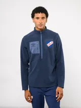 Buzo de micropolar azul con medio cierre frontal, cuello alto y bolsillo con cierre en el pecho. Presenta el logo de Umbro y el escudo del Club Nacional de Football.