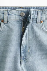 Short de media pierna en denim de algodón levemente elástico, de tiro alto con diseño de cinco bolsillos y cierre con botón.