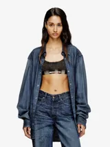 Bralette deportivo de suave algodón elástico con escote redondo, banda elástica inferior y estampado de pata de gallo con efecto desgastado tipo denim.