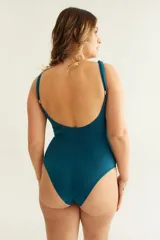 Malla entera color petróleo con escote en V, frunce en el delantero, breteles finos regulables y espalda baja. Presenta una flor removible en el bretel.