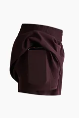 Short deportivo de doble capa color bordó, de corte estándar con cintura elástica fruncida y calza incorporada con bolsillo portacelular.