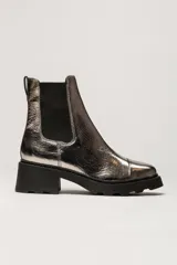 Bota tipo Chelsea de cuero metalizado plateado, con paneles elásticos laterales negros, suela track de goma negra y taco cuadrado.