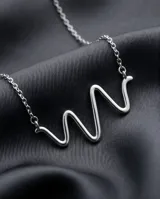 Collar de plata 925 con cadena fina y dije central con diseño abstracto de serpiente.