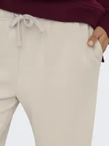 Pantalón jogger para mujer de tiro medio, pierna recta y wide leg, color beige, con cintura elástica y cordón ajustable.